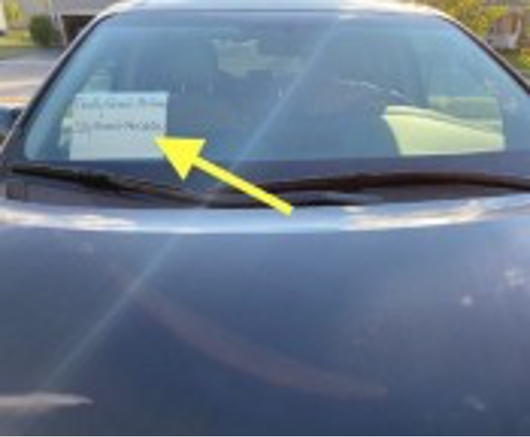 Parents must have a sign displayed in the passenger side of the windshield